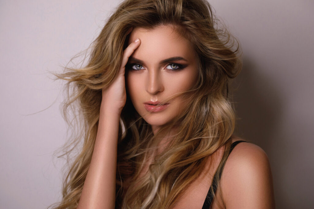 Gorgeous woman with a beautiful curly hair and professional make