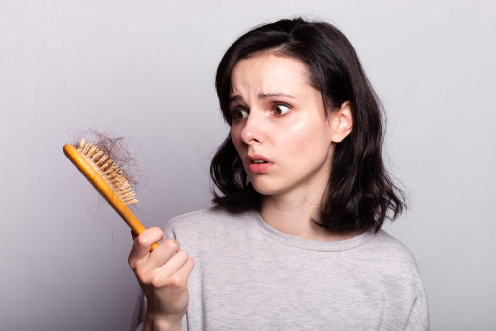 Beautiful woman comb hair grey shirt fall out Beautiful woman comb hair grey shirt fall out