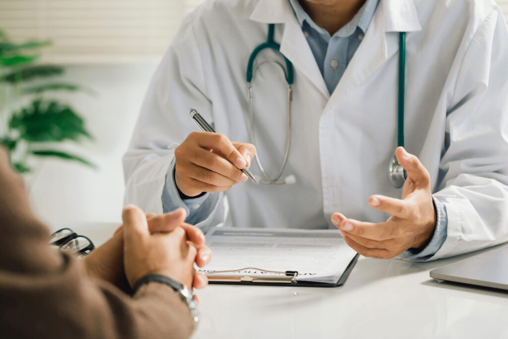 A professional physician in a white medical uniform talks to dis A professional physician in a white medical uniform talks to dis