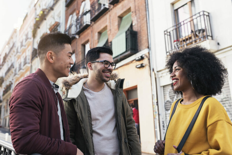 Group of happy friends chatting in the street. Group of happy friends chatting in the street.