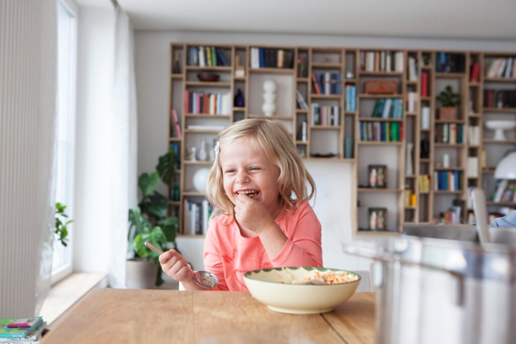Portrait of laughing little girl eating spaghetti Portrait of laughing little girl eating spaghetti