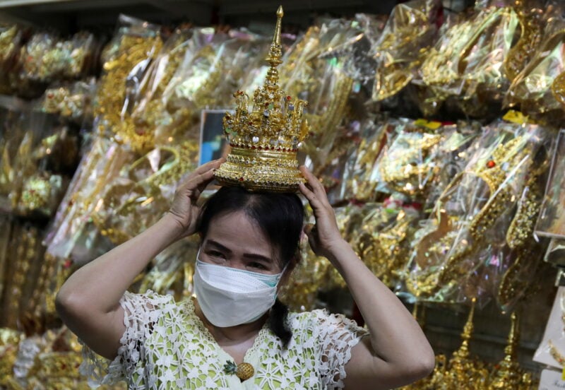 Shop keeper displays a Thai traditional costume head gear similar to one wore by K-pop singer Lisa at a shop selling merchandise items in Bangkok Shop keeper displays a Thai traditional costume head gear similar to one wore by K-pop singer Lisa at a shop selling merchandise items in Bangkok