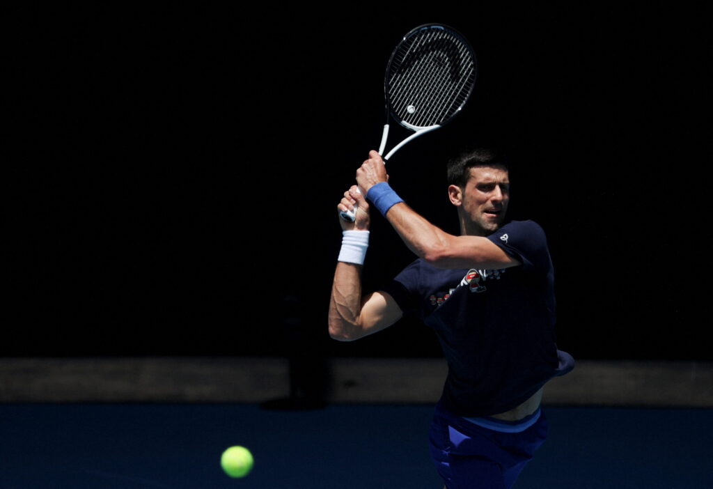 Serbian tennis player Novak Djokovic practices at Melbourne Park as questions remain over the legal battle regarding his visa to play in the Australian Open