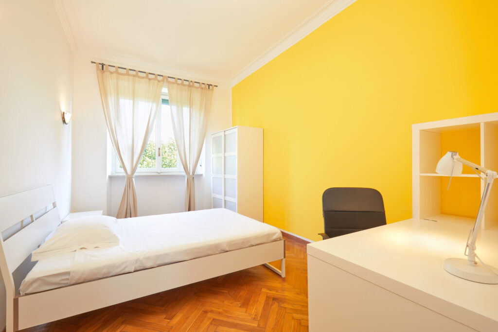 Bedroom for rent in renovated apartment with yellow wall and whi Bedroom for rent in renovated apartment with yellow wall and whi