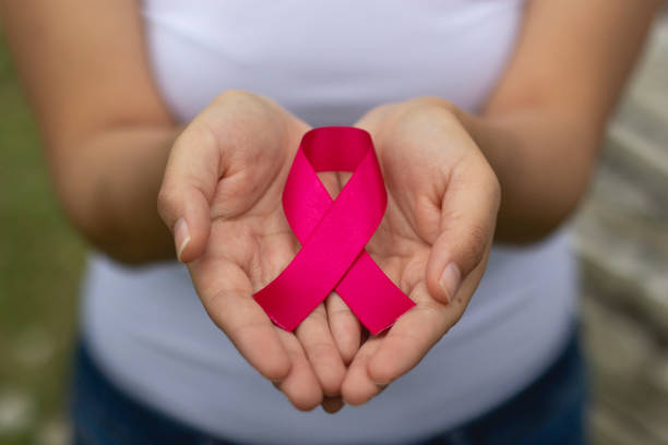 Woman with pink ribbon in support of breast cancer Woman with pink ribbon in support of breast cancer