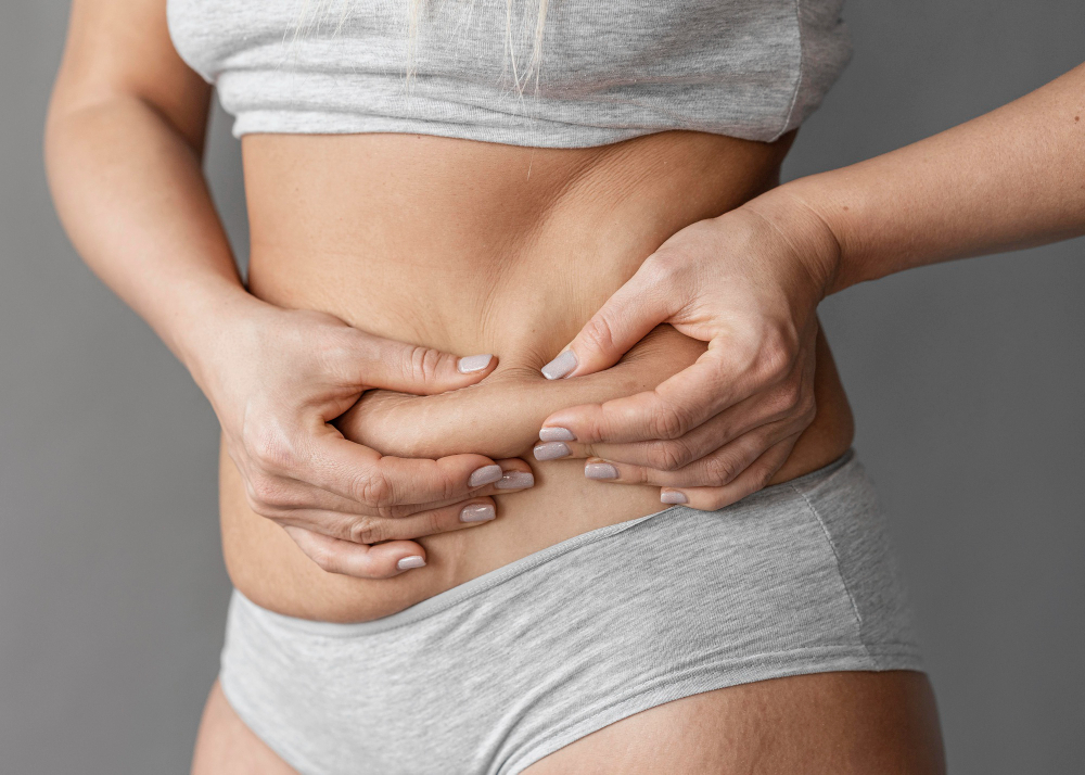 close-up-hands-holding-belly-fat
