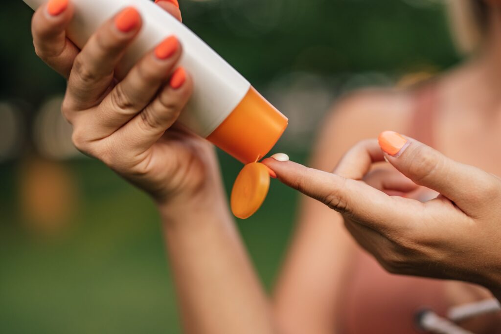 Close-up image of a woman putting on sun lotion. Close-up image of a woman putting on sun lotion.