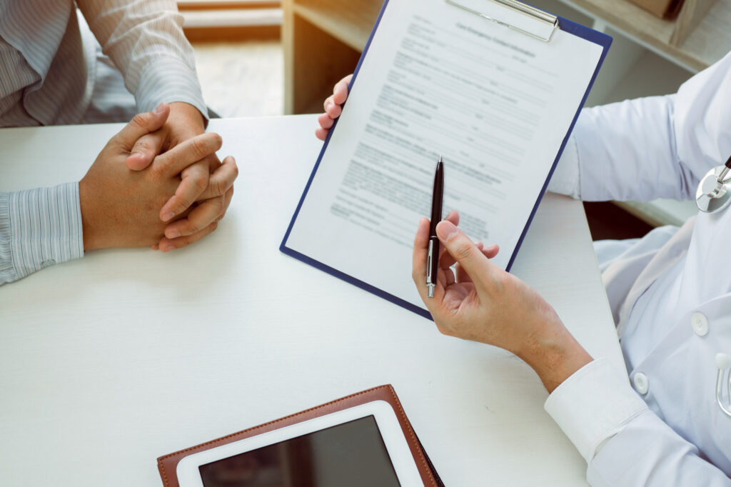 Confident female doctor reviews patient medical information and