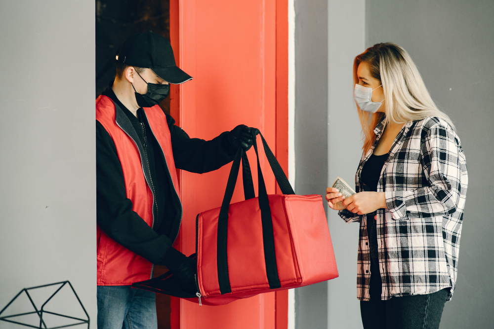 delivery-man-in-a-medic-mask-with-woman delivery-man-in-a-medic-mask-with-woman