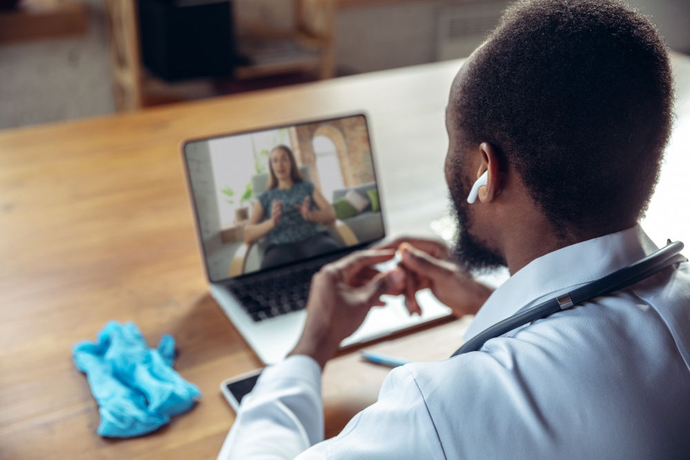 doctor-advising-the-patient-online-with-laptop doctor-advising-the-patient-online-with-laptop
