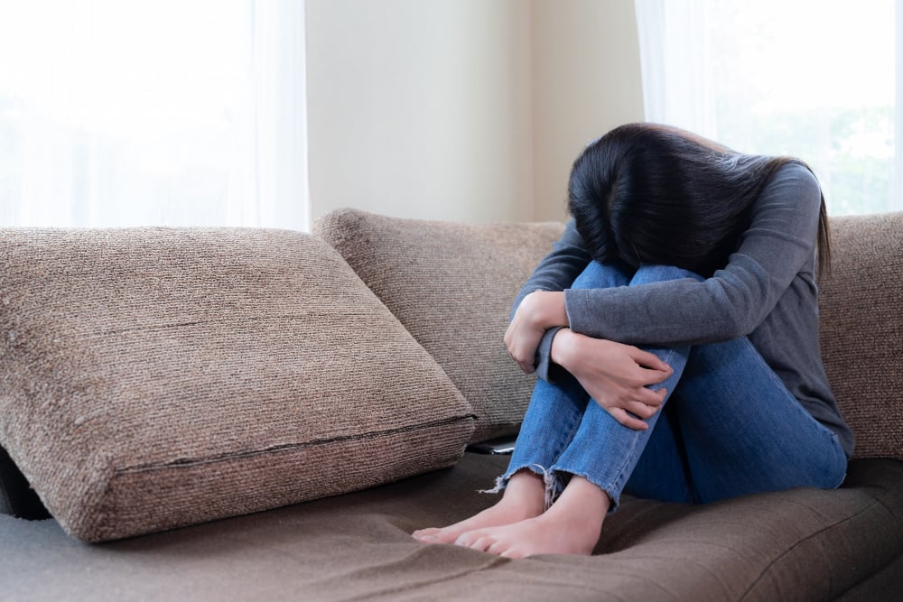 emotional-young-woman-was-depressed-on-sofa