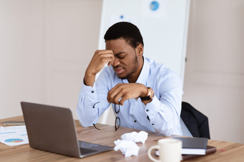 Exhausted african american manager suffering from burnout Exhausted african american manager suffering from burnout