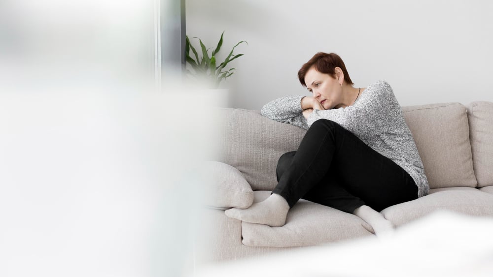 front-view-of-woman-sitting-on-couch