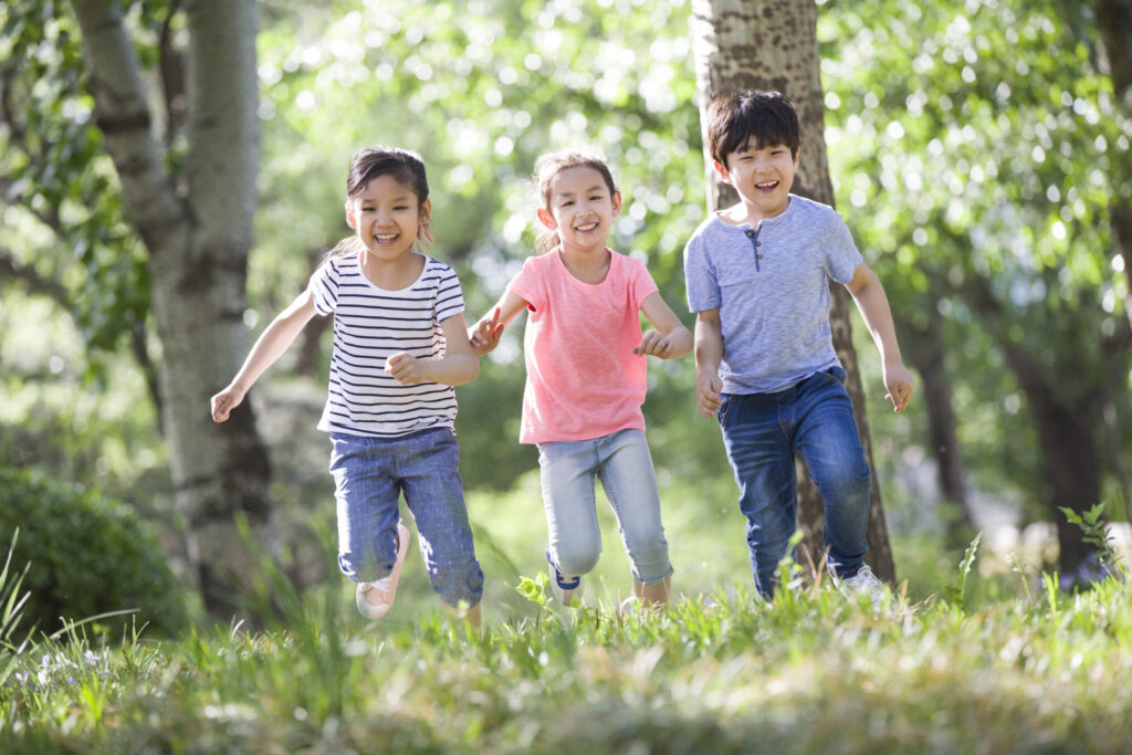 Happy Chinese children racing in woods