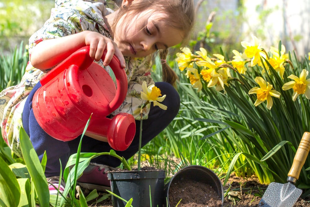 little-girl-planting-flowers-in-the-garden