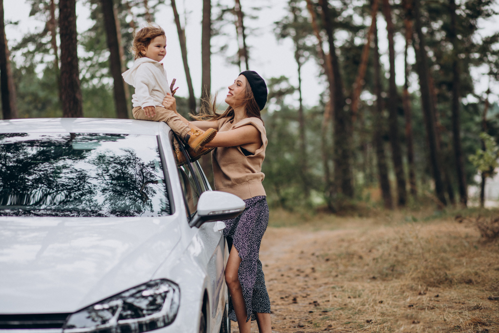 mother-with-her-son-by-the-car-in-park