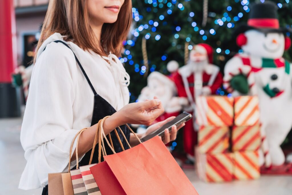 Young woman with shopping bags at shopping mall, Christmas sale concept Young woman with shopping bags at shopping mall, Christmas sale concept