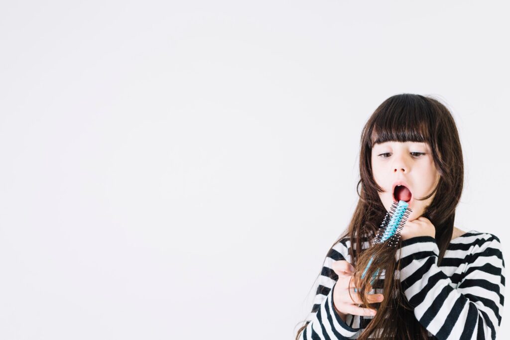shocked-girl-trying-to-comb-hair-scaled shocked-girl-trying-to-comb-hair-scaled