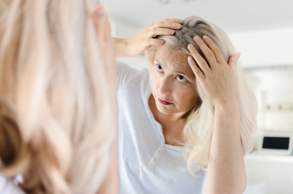 Senior,Beautiful,Woman,Cheking,For,Grey,Hair,In,Front,Of Senior,Beautiful,Woman,Cheking,For,Grey,Hair,In,Front,Of