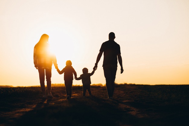 silhueta-de-familia-feliz-na-sunset_1303-22466