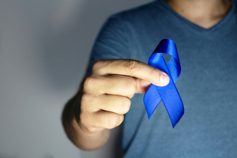 Blue november – man holding blue ribbon