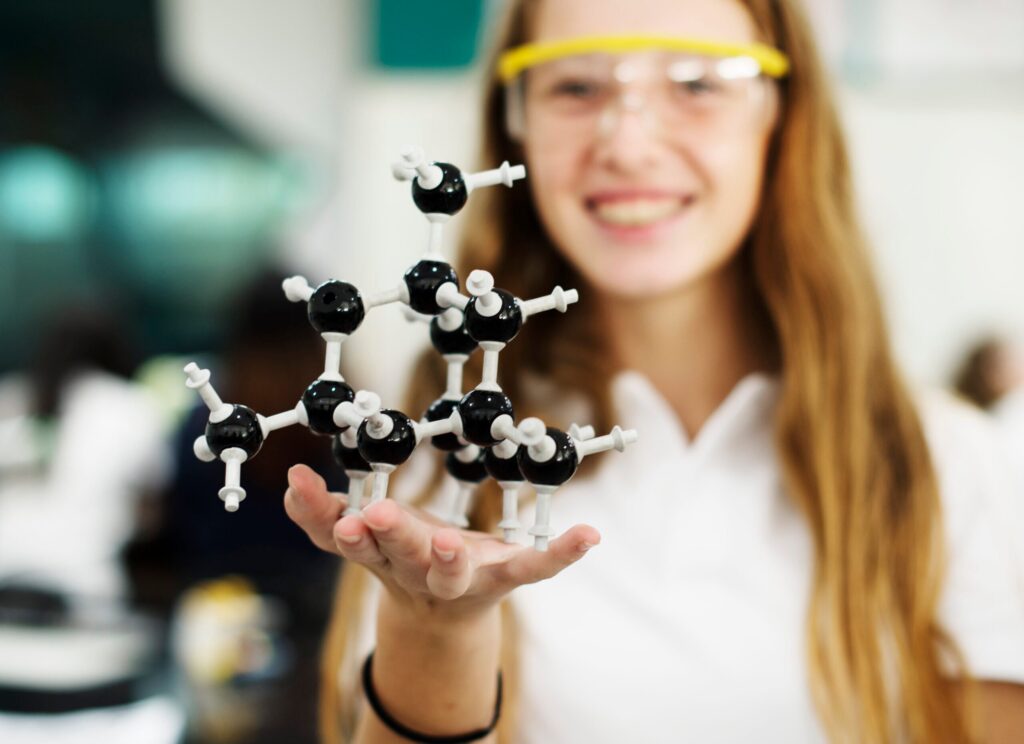 Student girl holding molecule on her hand Student girl holding molecule on her hand