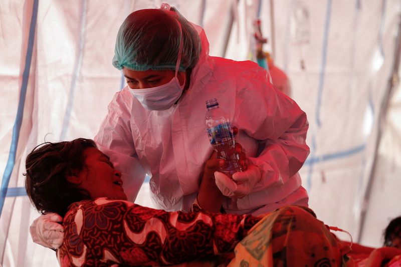 Profissional de saúde cuida de paciente com Covid-19 na Indonésia
