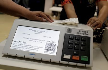 Brazilian electoral workers seal electronic ballot boxes in Manaus