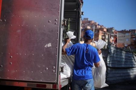 Membro do Favela Brasil Xpress com produtos a serem entregues em Paraisópolis, São Paulo Membro do Favela Brasil Xpress com produtos a serem entregues em Paraisópolis, São Paulo