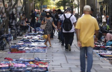 Pessoas caminham em meio a produtos expostos por camelôs no centro do Rio de Janeiro