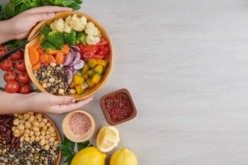 top-view-person-raising-salad-bowl-min-scaled-e1647279439871