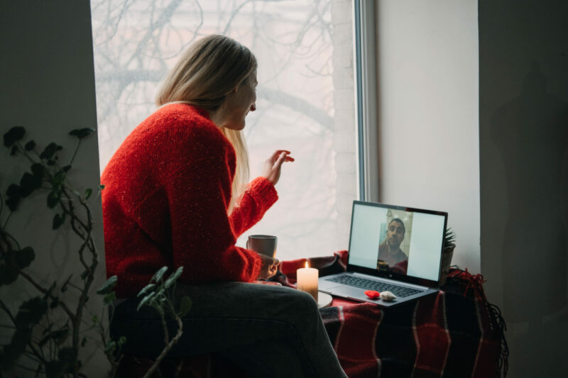 Woman using online dating app on laptop. Valentines Day, dating, meeting During The Coronavirus Outbreak. Love at distance in the time of coronavirus.