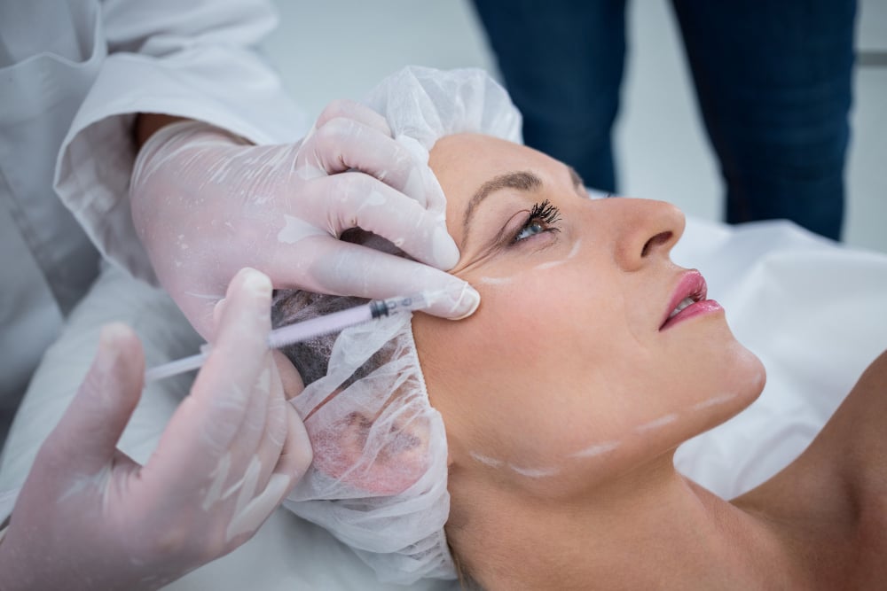 woman-with-marked-face-receiving-botox-injection