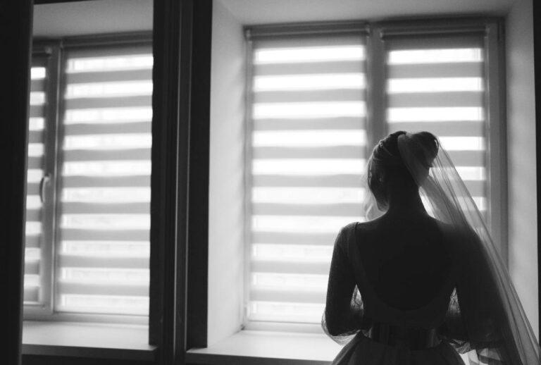 Noiva de costas em frente a janela