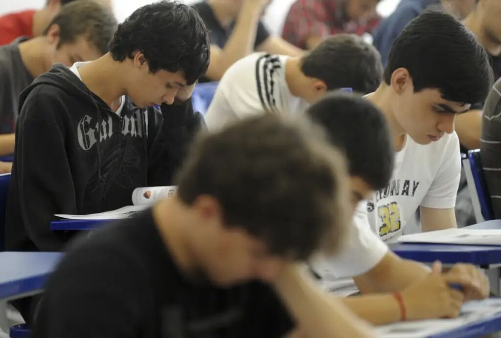 Estudantes realizando uma prova em sala de aula.