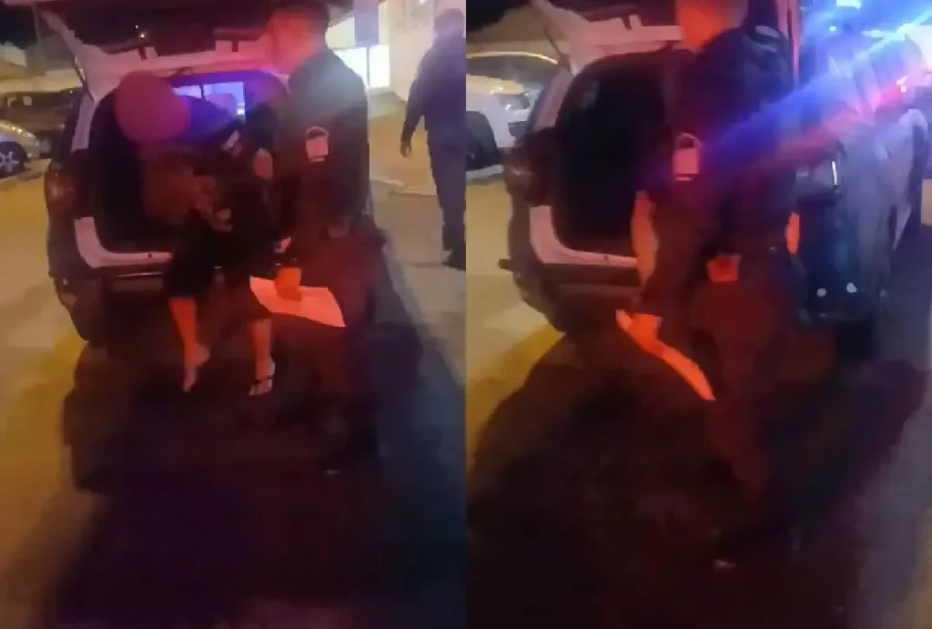 Homem sendo preso após agredir companheira