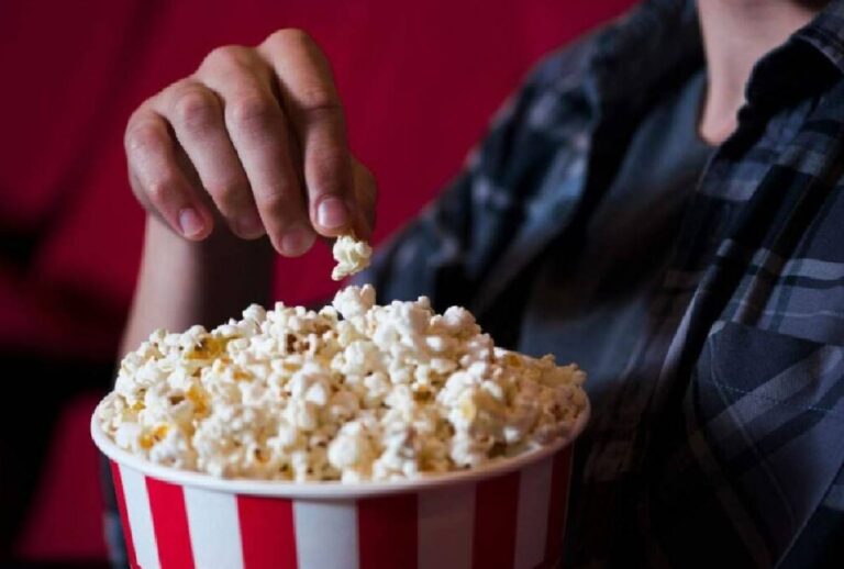 Pessoa segurando balde de pipoca