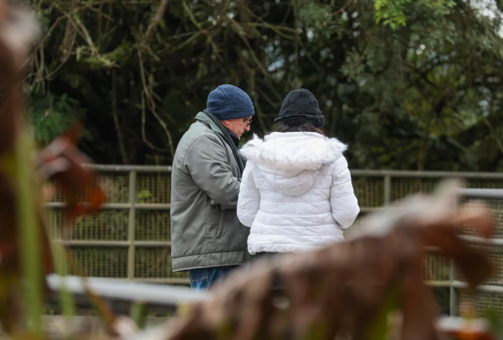 Casal agasalhado em parque da capital por conta do frio
