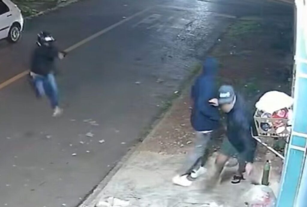 Câmeras flagraram um jovem sendo morto a tiros dentro de uma distribuidora em Curitiba. PM suspeita de acerto de contas.